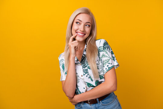 Photo of cunning tricky woman with straight hair dressed shirt look empty space finger on lips isolated on yellow color background
