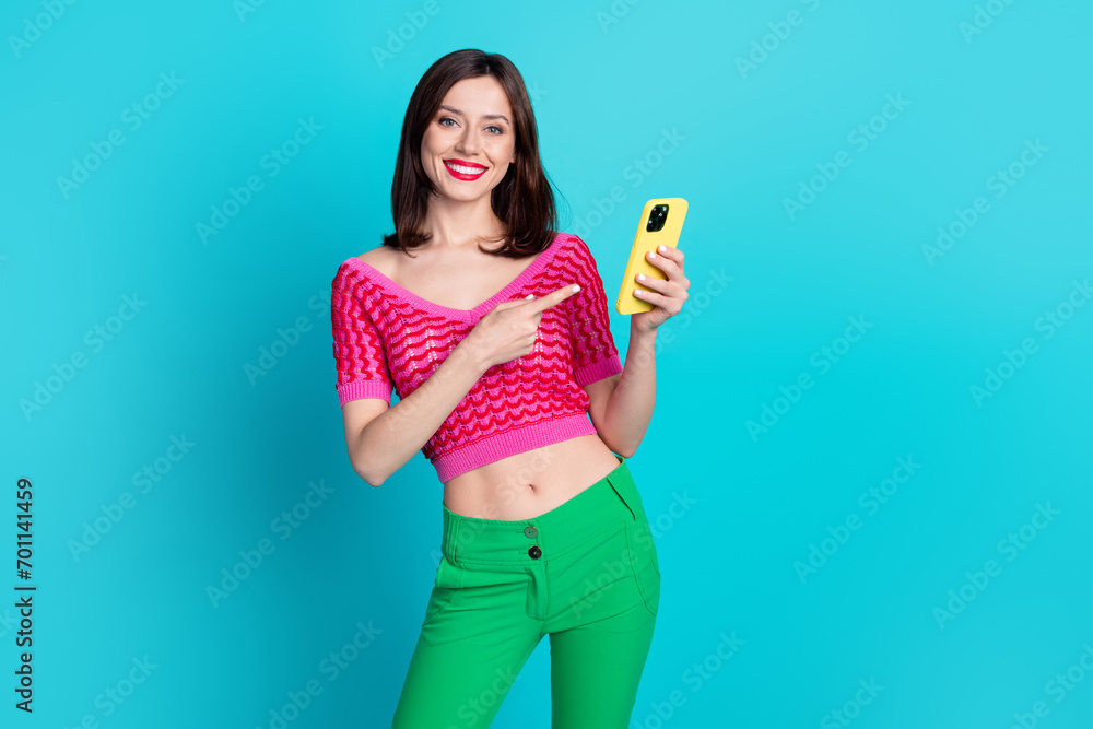 Poster Photo of positive millennial girl web promoter demonstrate new electronics brand gadget isolated blue color background