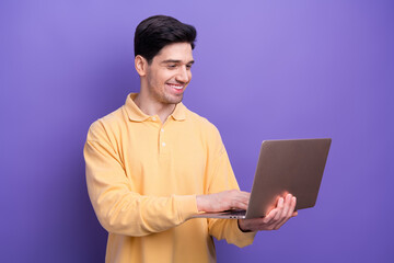 Photo of positive charming guy wear yellow polo chatting instagram twitter telegram facebook...