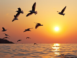 Fototapeta premium Sunset over the sea, birds gracefully soar against the sunlight-filled sky