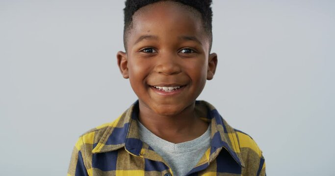 Young, child and face happy in studio on grey background for confident smile, good mood or positive attitude. Black person, kid and portrait for growth development or relax expression, casual mockup