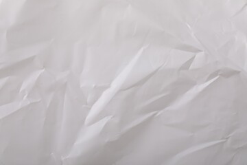 Crumpled white paper bag as background, top view