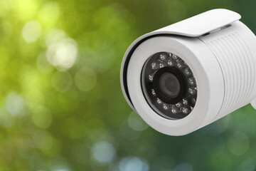 Modern security CCTV camera outdoors, closeup. Space for text