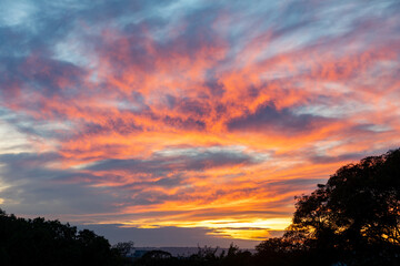 Idyllic blue sky and orange and multicolored clouds