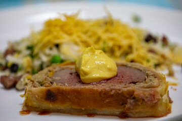 Traditional and Perfect homemade juicy Beef Wellington, tenderloin dish on rustic wooden table. Christmas food