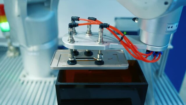 robot with vacuum suckers with conveyor in manufacture phone factory,Smart factory industry 4.0 concept.