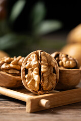 Walnuts are placed on a rustic old wooden table