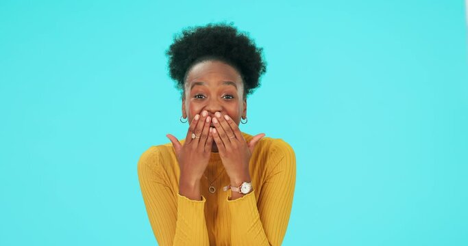 Face, smile and black woman excited, surprise and winning on a blue studio background. Portrait, female model or person with facial expression, omg or wow with winner, announcement or emoji with news