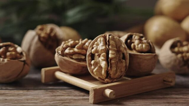 Walnuts are placed on a rustic old wooden table