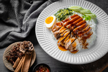 Braised pork leg with boiled eggs and rice on a plate