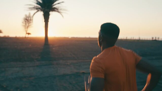 Man, back and running in park at sunrise, fitness and cardio outdoor for body health and wellness. Training, exercise and sports, runner in race or marathon with sunshine, nature and healthy athlete