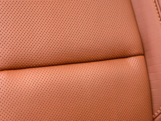 Part of leather car headrest seat details. Сlose-up  brown   perforated leather car seat. Skin...