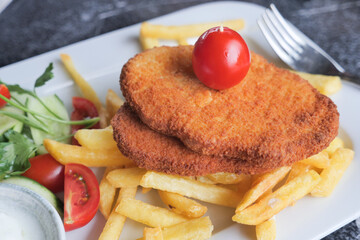  Chicken schnitzel served with potato chips 