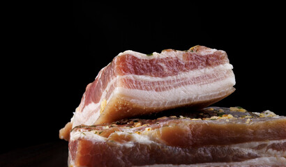 Appetizing salty lard with layers of meat. Salted lard with garlic and herbs.