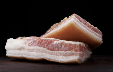 Appetizing salty lard with layers of meat. Salted lard with garlic and herbs.