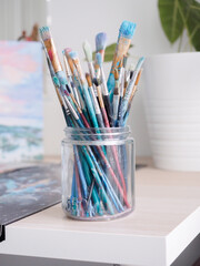 artist paintbrushes in glass jar