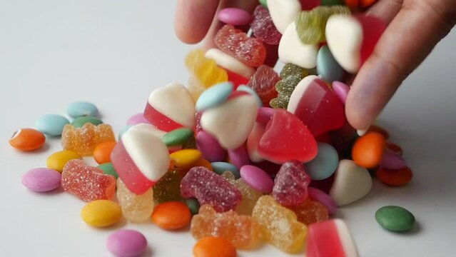  slow motion of dropping colorful candy sweet jelly 