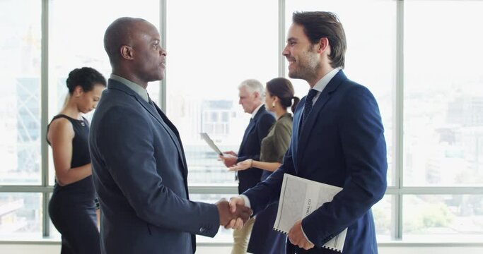 Business people, handshake and meeting for partnership, professional introduction and hello in law firm lobby. Corporate lawyer, men and clients shaking hands with documents for advice or consulting