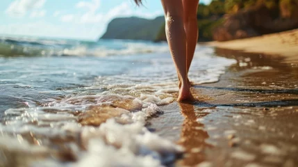 Raamstickers Closeup of woman feet walking on sand beach © waranyu
