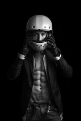 A man with a suit and a motorcycle helmet. Naked torso.