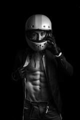 A man with a suit and a motorcycle helmet. Naked torso.