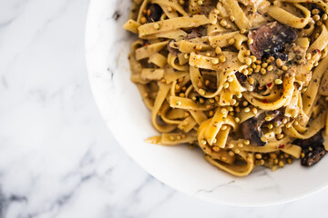 plant-based fettuccine pasta with mushroom and coriander seeds