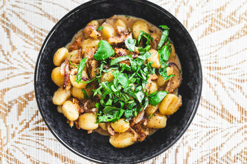 plant-based gnocchi with mock meat chicken and fresh herbs