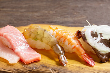 Assorted sushi on a wooden tray