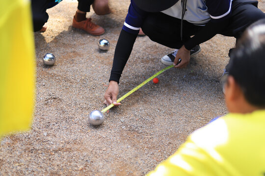 referee measure distance in playing Petanque in sportday of school