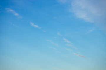 Fototapeta premium A beautiful sky tinted by the sun leaving vibrant shades of gold, pink, blue and multicolored. Clouds in the twilight evening and morning sky. Cloudy sky background in the evening and during the day.