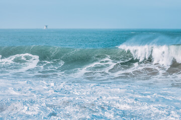 Fototapeta premium Wave splashing close-up. Crystal clear sea water, in the ocean in San Francisco Bay, blue water, pastel colors.
