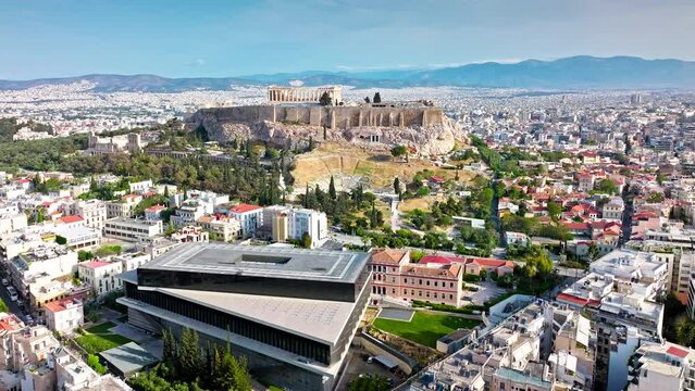 Aerial view of the Acropolis Museum and Ruins of the iconic temple Acropolis of Athens in Greece. Ultra Modern glass and steel museum housing ancient artefacts from the Acropolis archaeological site.