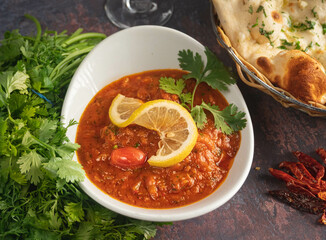 Delicious chicken curry with butter naan. lemon, tomato, and coriander.