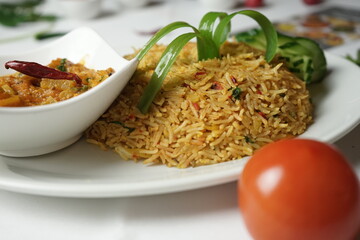 Biriyani rice with vegetables and meat.