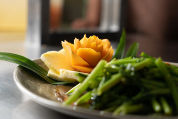 Thai herb stir fry morning glory or water spinach. Served with pineapple and mango.