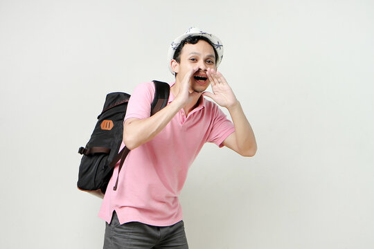 Asian man backpacker shouting outloud. digital nomad and travelling concept. on isolated background