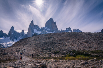 Group of people trekking to the campsite with Mt.Fitzroy as the background and fantastic sun and...