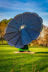 Rotating solar panel in flower shape in a city park. Photovoltaic, alternative electricity source