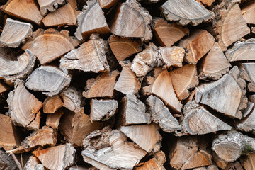 Stacked firewood. Preparation of firewood for the winter. Stocks of wooden firewood. Stacked firewood. Village lifestyle.