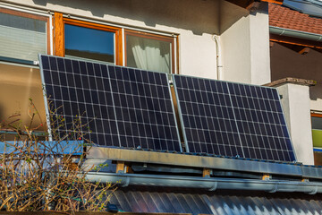 Balcony solar power plant. Solar battery on balcony wall. Mini PV plants generate your own electricity plug play.