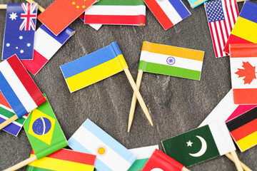 Fototapeta na wymiar The concept is diplomacy. In the middle among the various flags are two flags - India, Ukraine