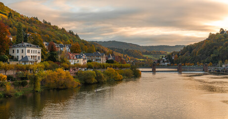 Fototapeta na wymiar Beautiful morning view with warm colors on the riverbanks of the Neckar river. Beautiful historical city of Heidelberg in Germany.