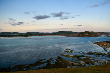 The view of the sunset with a beautiful sky and a boat on the beach