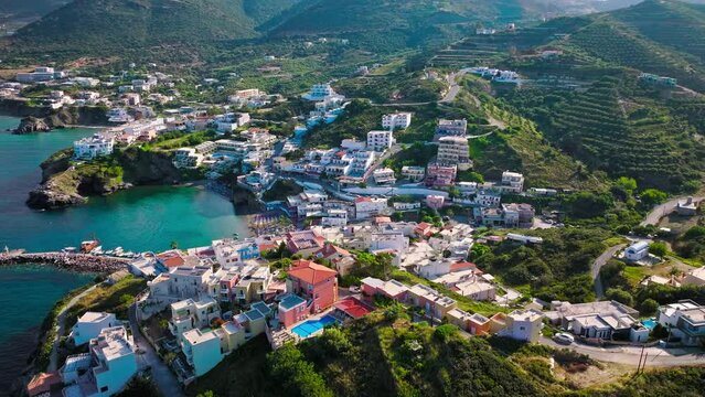 Aerial view of tourist resort hotels and Livadi Beach in Crete, Greece. Luxury villas by Bali Seaside Village with turquoise crystal clear water on Greek Island.