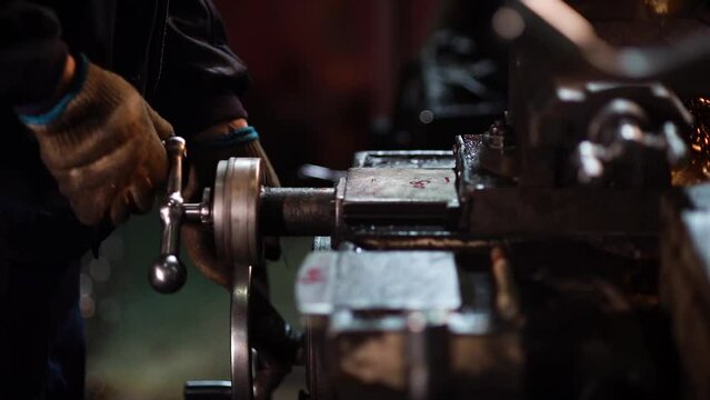 Close up of a factory worker in china working on a lathe, workplace safety, cinematic