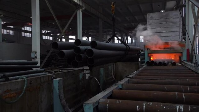 Loading new pipes just made in a metallurgical furnace at a factory in China