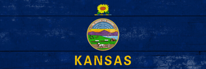 Kansas State flag on a wooden surface. Banner of the grunge Kansas State flag.