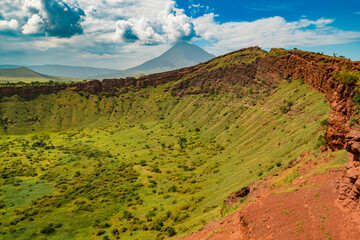 Panoramic view of Shimo la Mungu - God's Pit at the edge of Makonde Plateau with Mount Ol Doinyo Lengai in the background in Tanzania