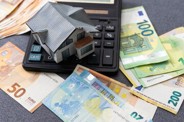 Layout of a house, banknotes , calculator lying on the table. Insurance, credit, mortgage, real...