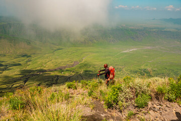 A hiker against a mountain background at Mount Ol Doinyo Lengai in Tanzania 